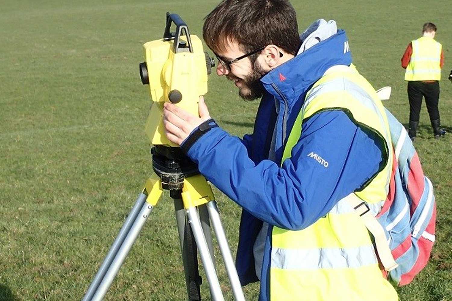 A student operates a piece of equipment on a field trip
