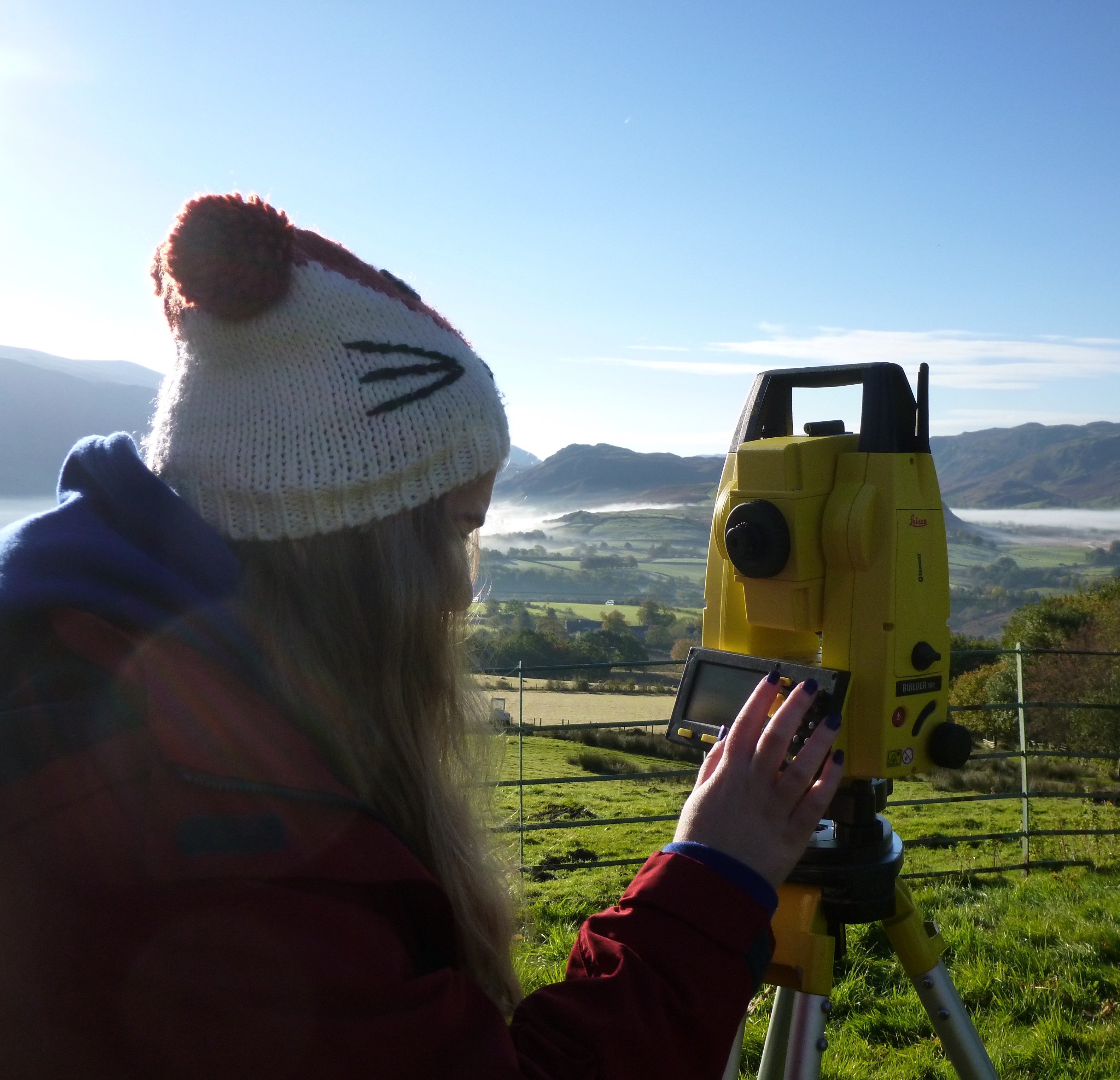 A student operates a piece of equipment on a field trip