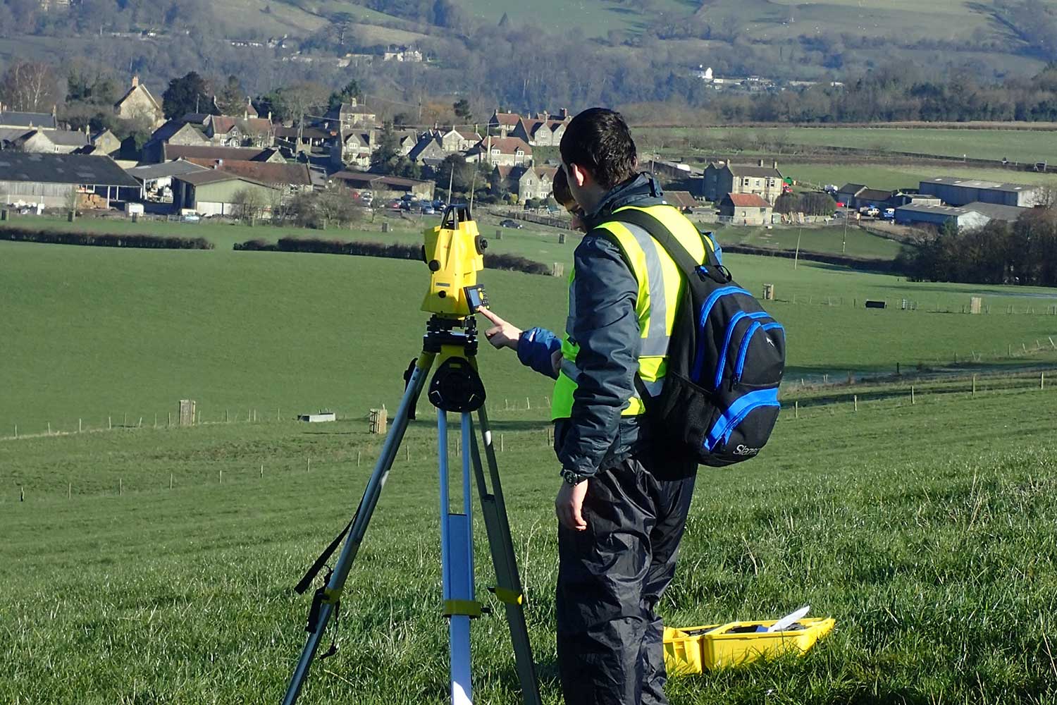 Two students operate equipment on a fieldtrip