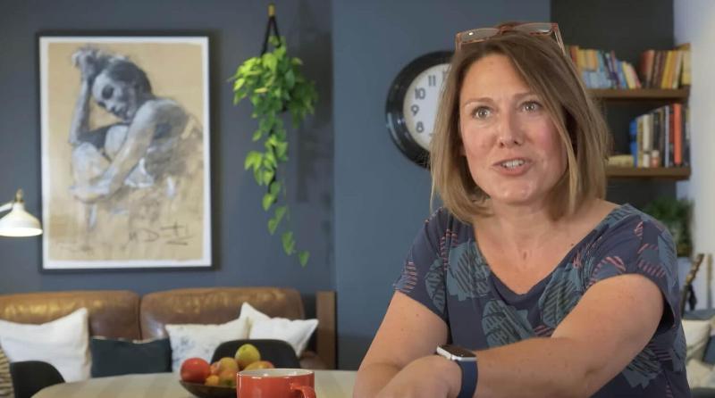 Woman talking to camera from her stylish living room