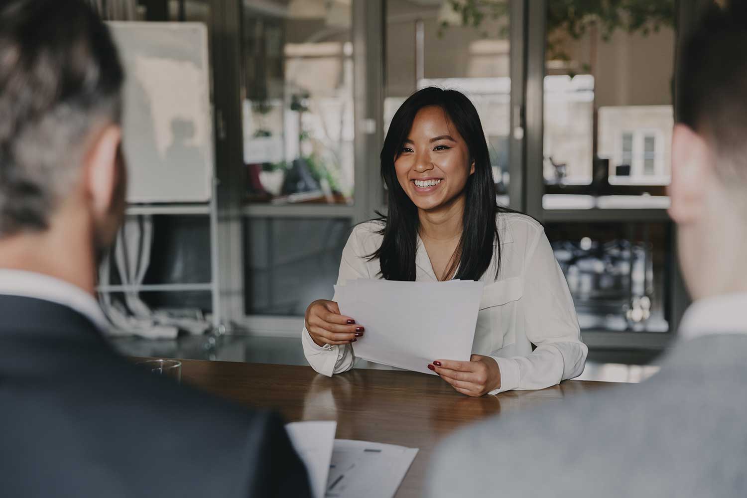 Two employees interview a job applicant