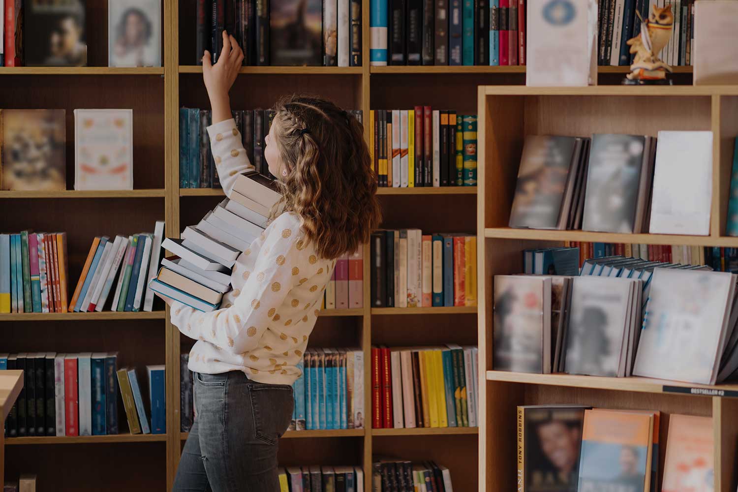 A student reaches for a library book