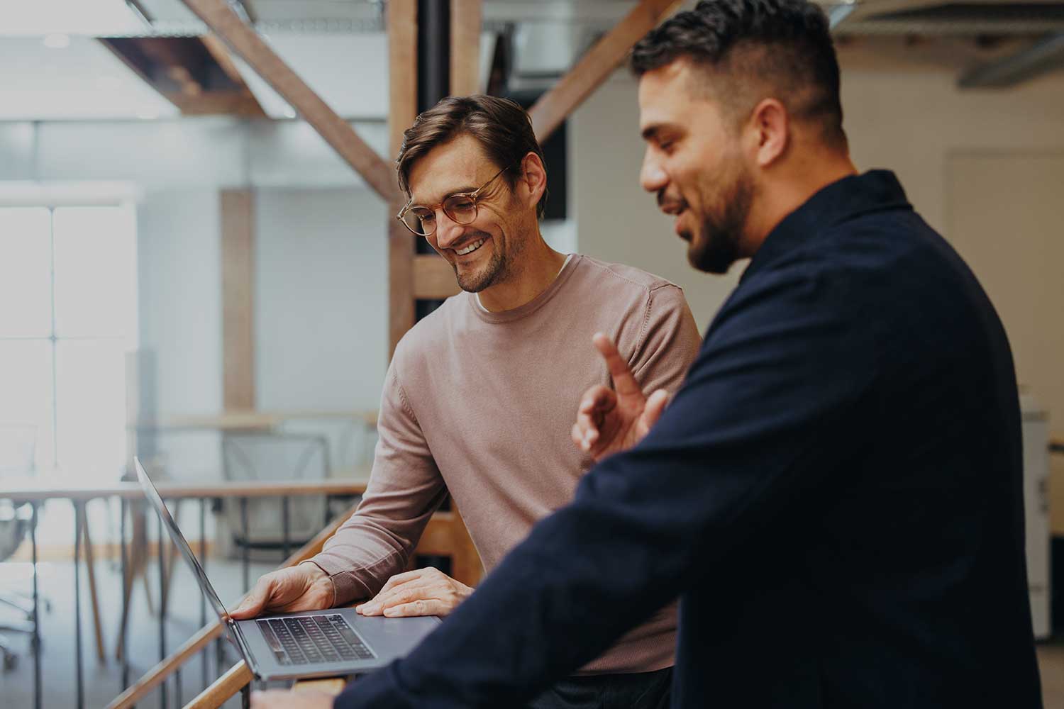 Two male employees having a discussion