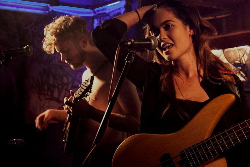 Students in a band performing on stage