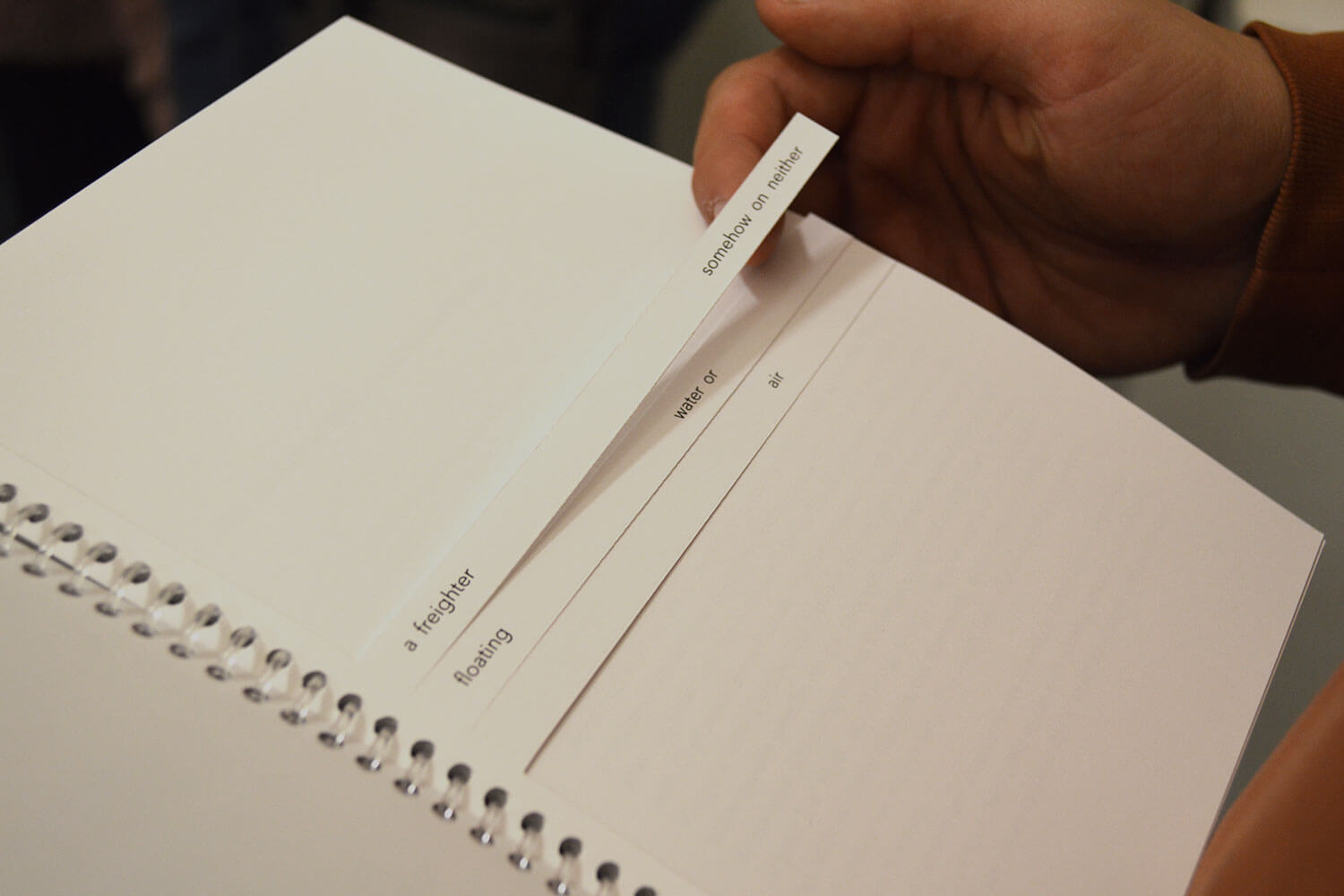 Booklet with the words 'a freighter floating somehow on neither water or air'.