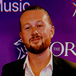 Portrait photo of a young smiling man with a beard