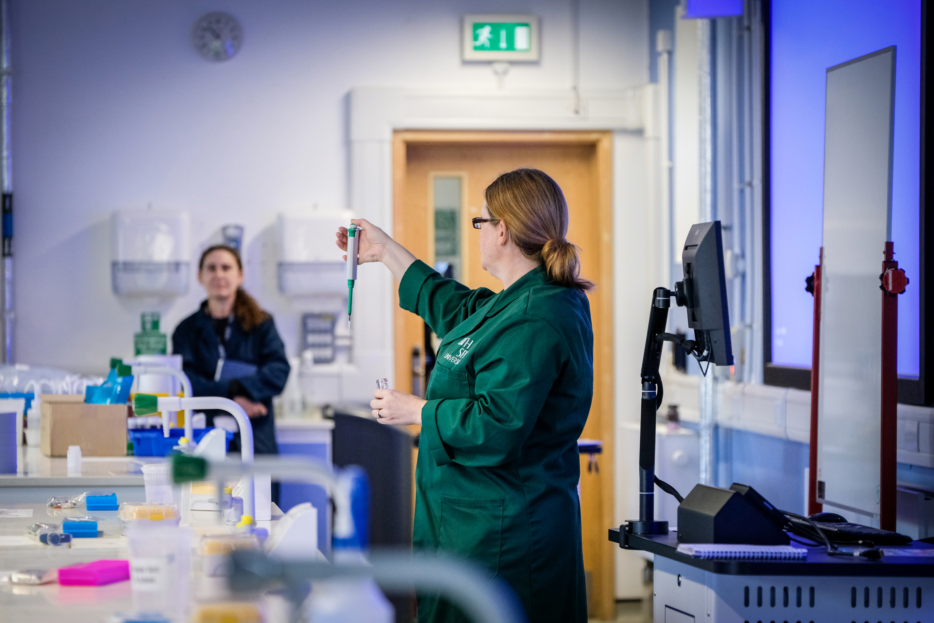A science lecturer demonstrates an experiment to students