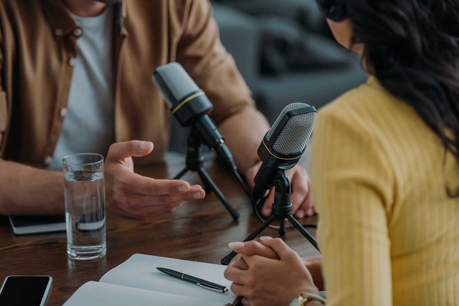 Two people recording a podcast