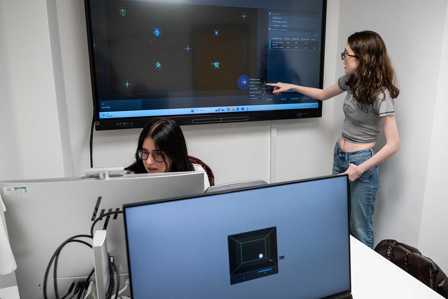 Two students using equipment in the eye tracking lab