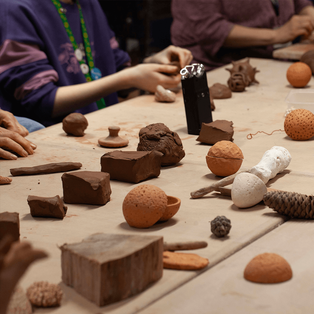 A group of people making objects out of clay
