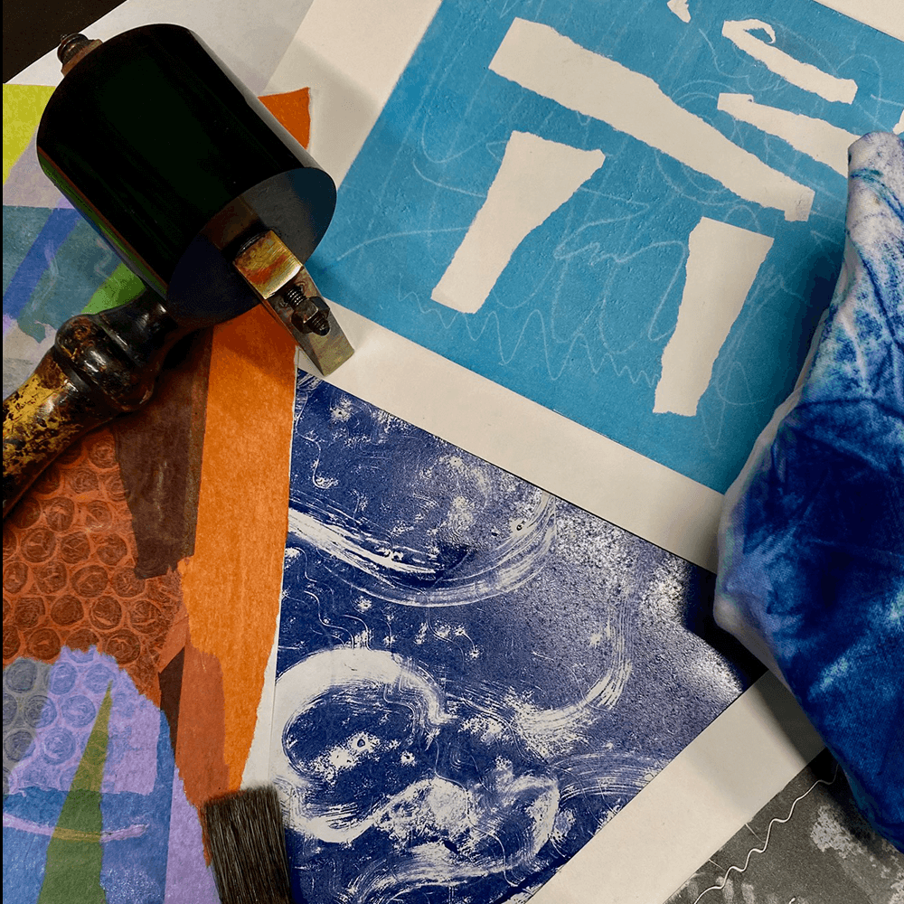 A collection of coloured prints and rollers to print with