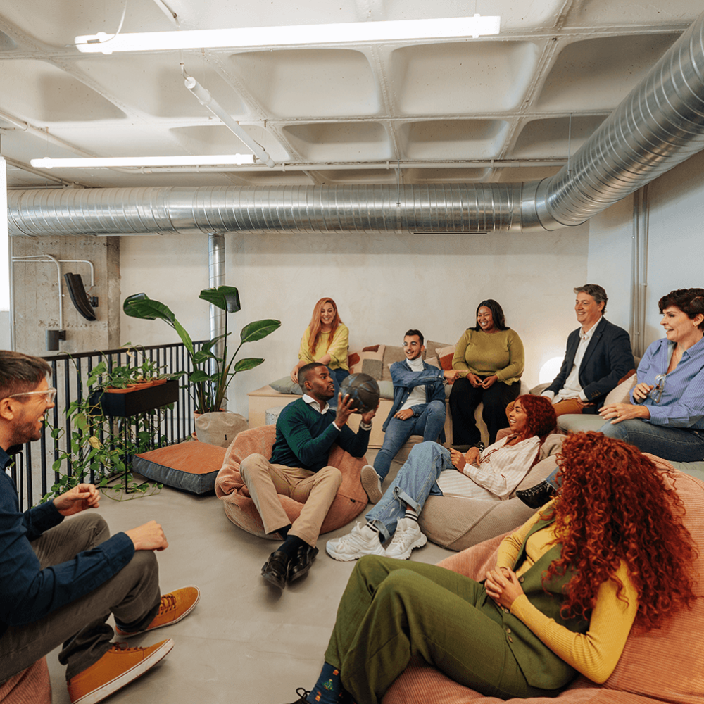 A group of people sat on sofas talking to each other