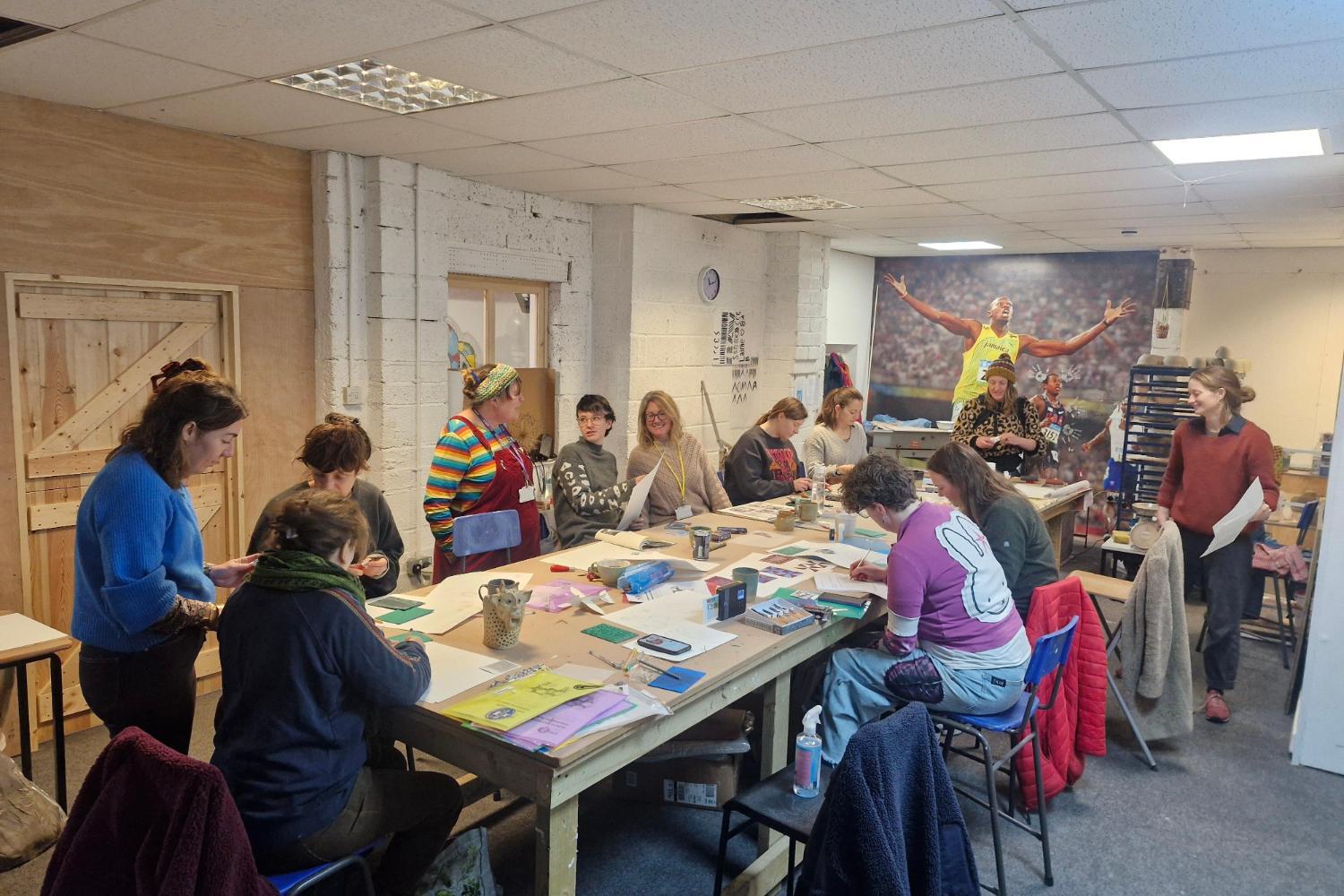 Photograph of a group of people in informal studio print making