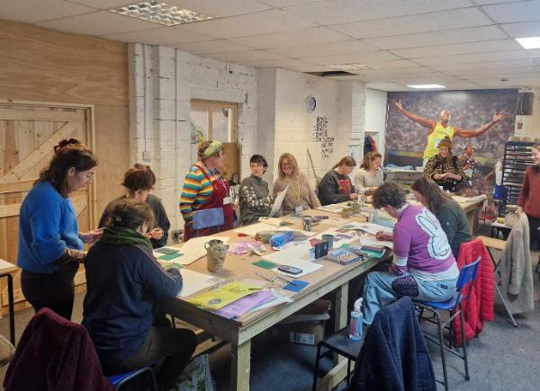 Photograph of a group of people in informal studio print making