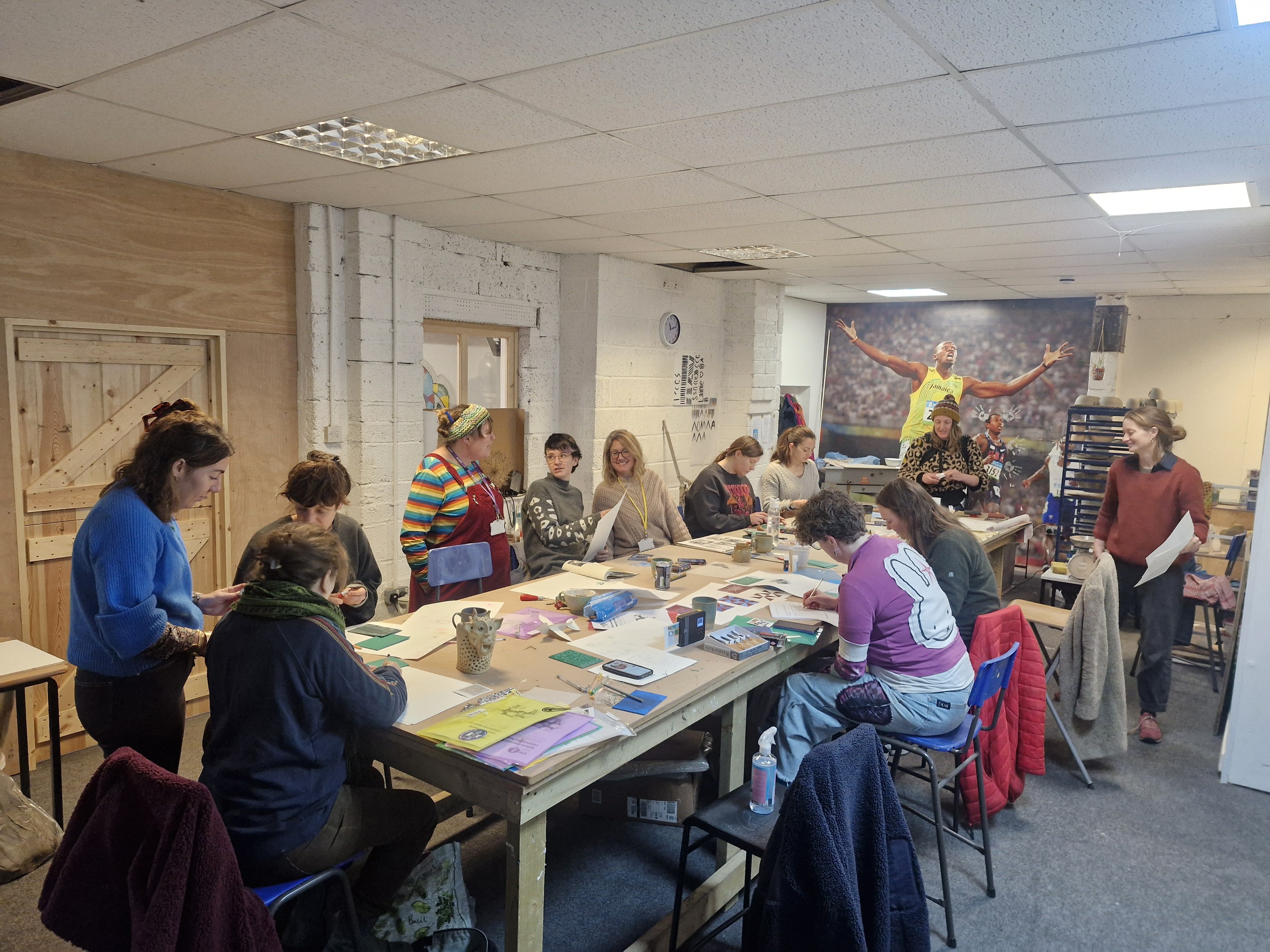 Photograph of a group of people in informal studio print making
