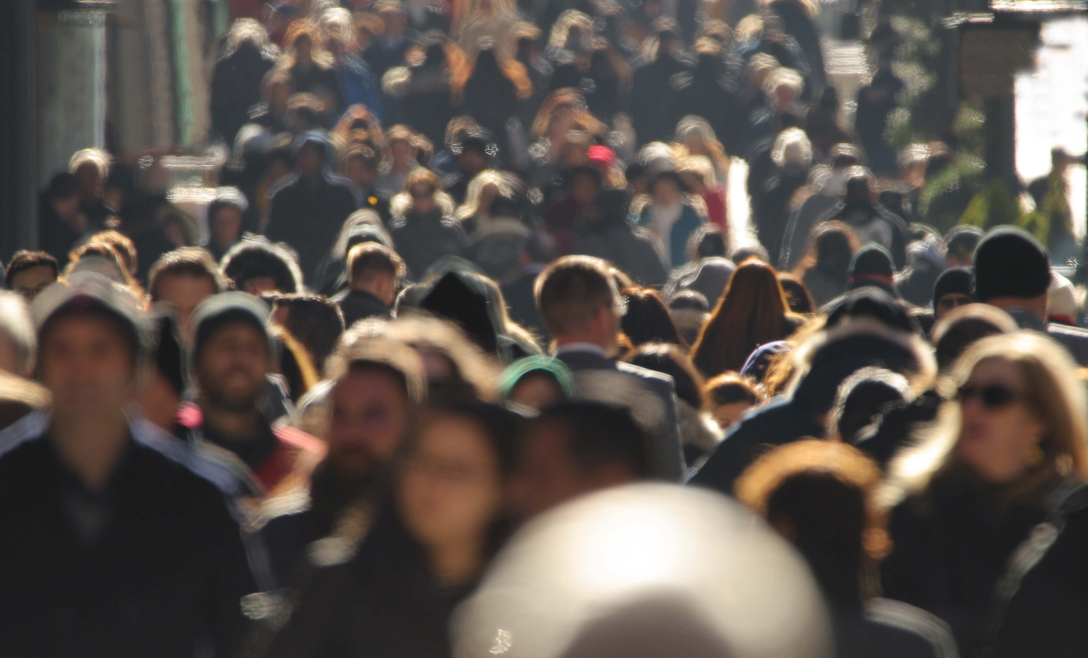 Crowds of unidentifiable people fill the street