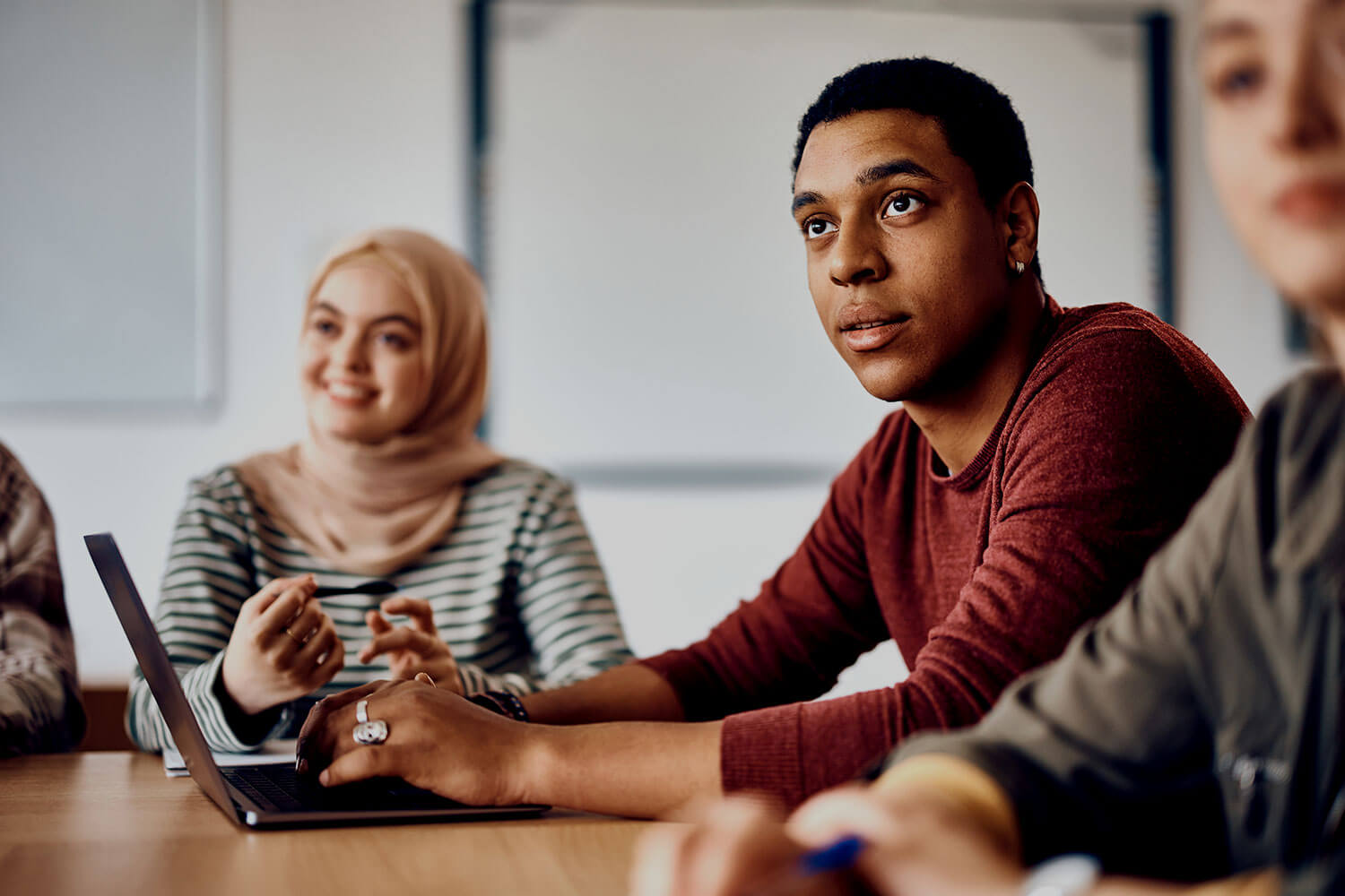 Male student paying attention during class at university