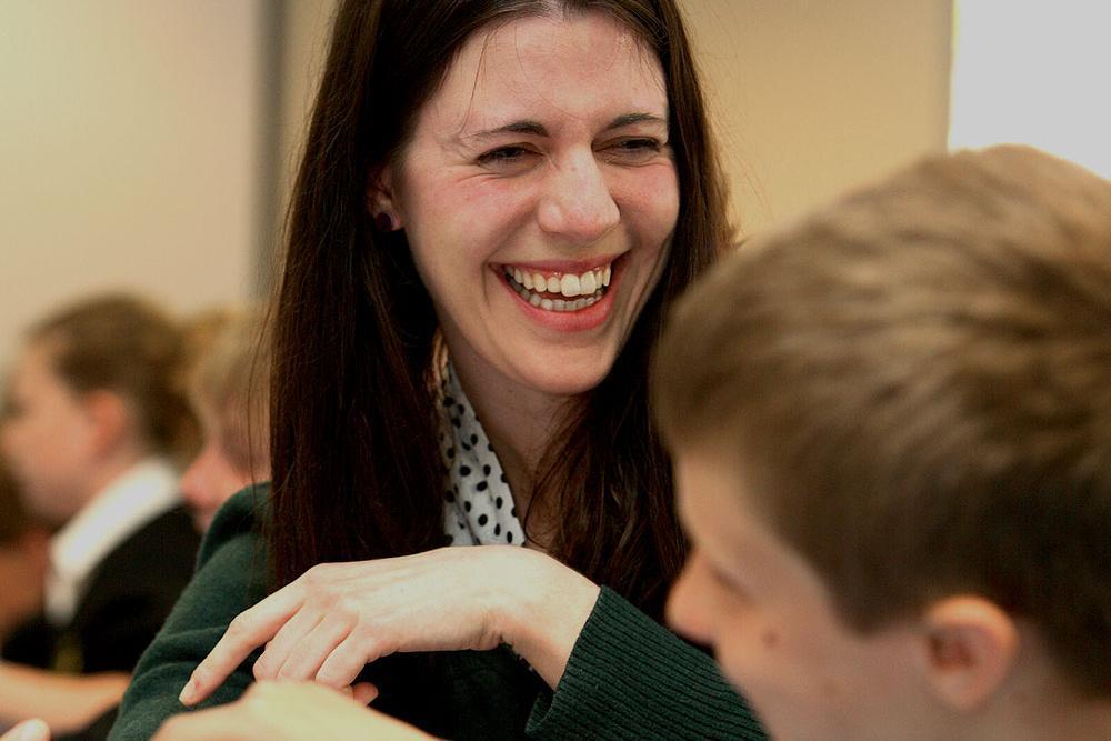 A smiling teacher with her students