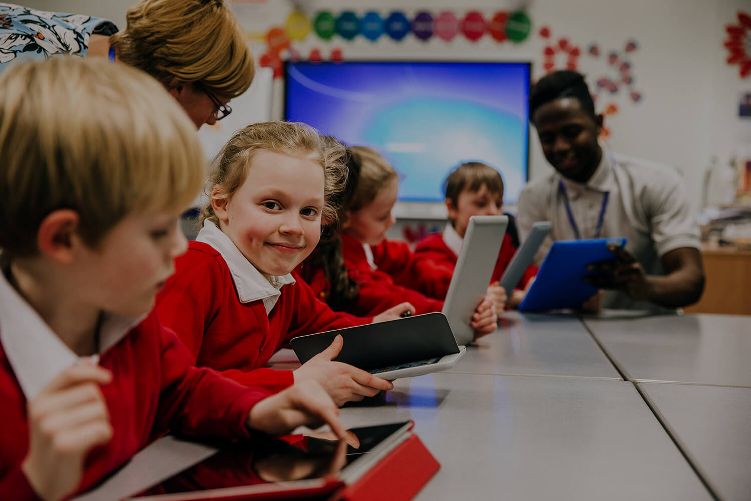 Primary school children in the classroom on tablets