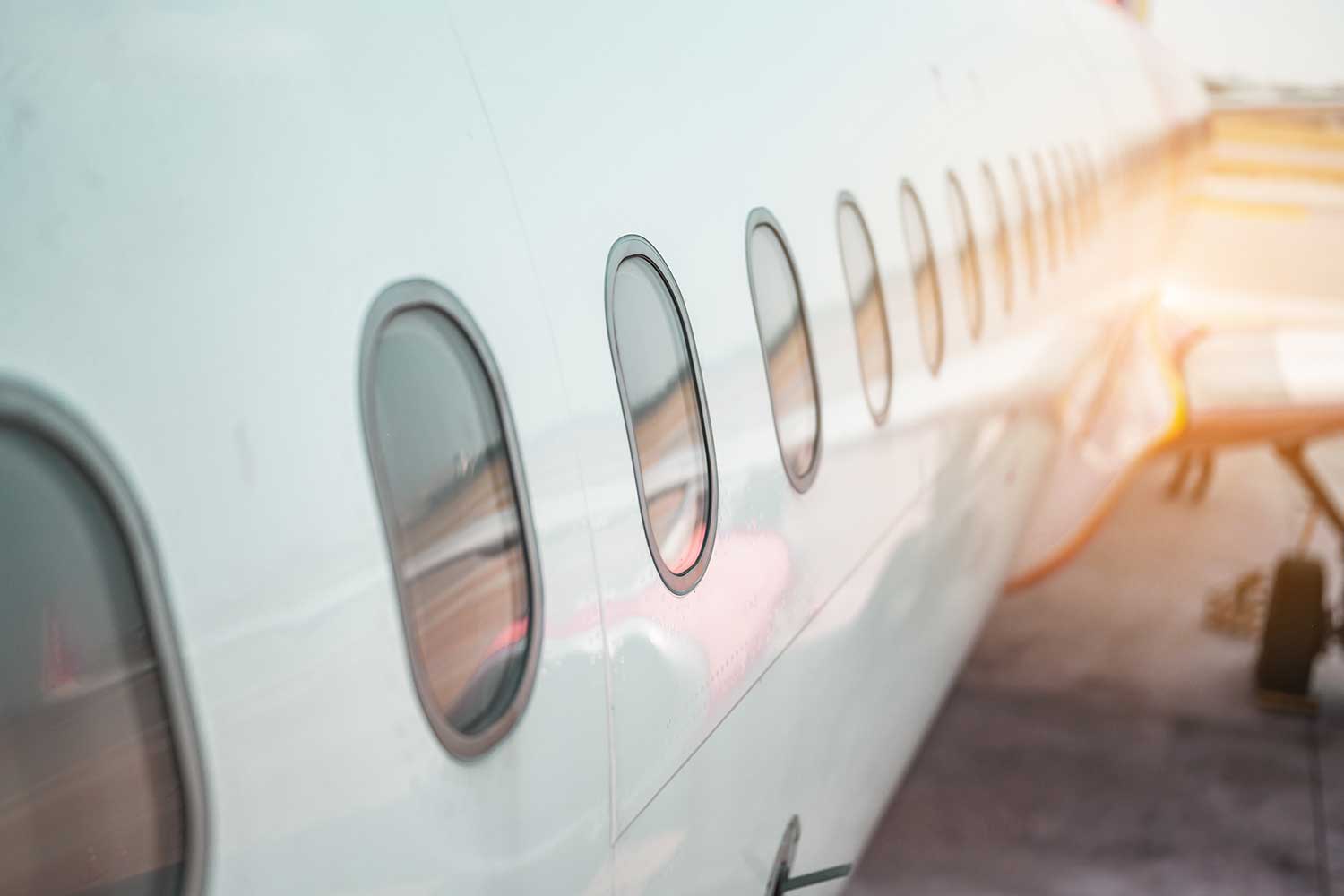 An abstract close-up of plane windows at sunset
