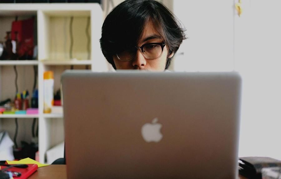 Student typing on laptop