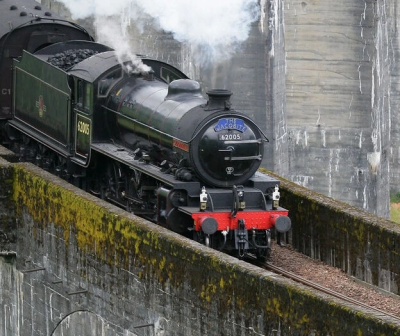 An image of a steam train crossing a bridge