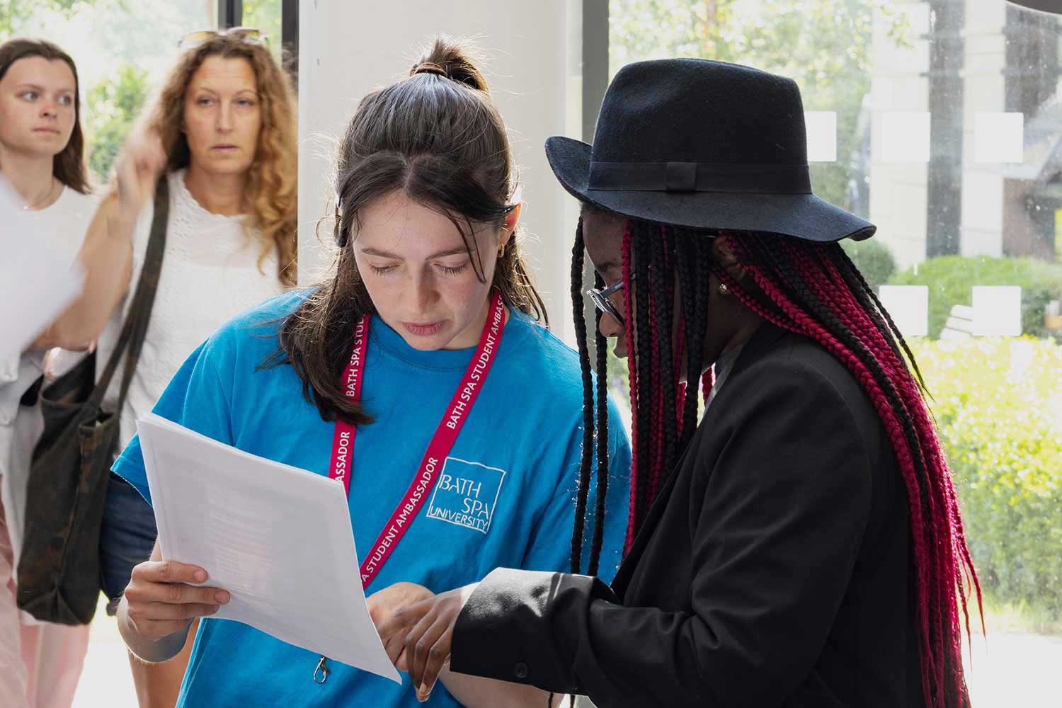 A Student Ambassador helps a visitor at an Open Day