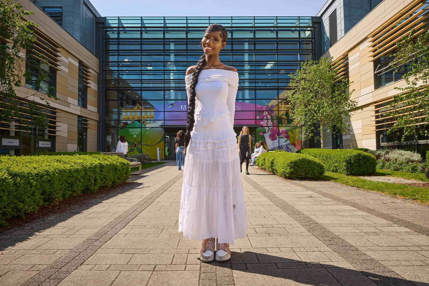 Photo of student in white dress outside Commons