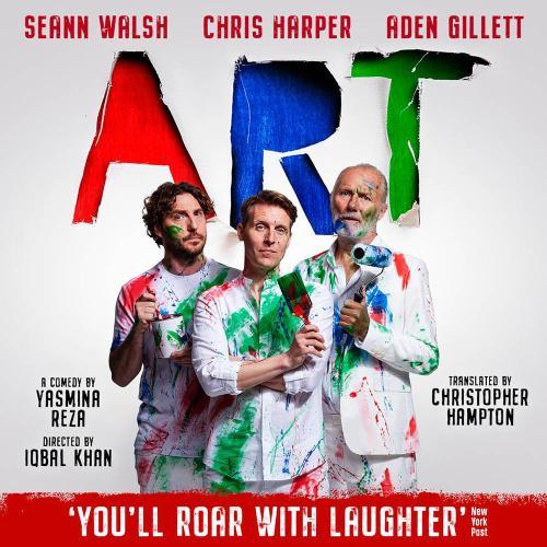 Promotional image of three men dressed in white, covered in green and red paint with the word ART printed at the top