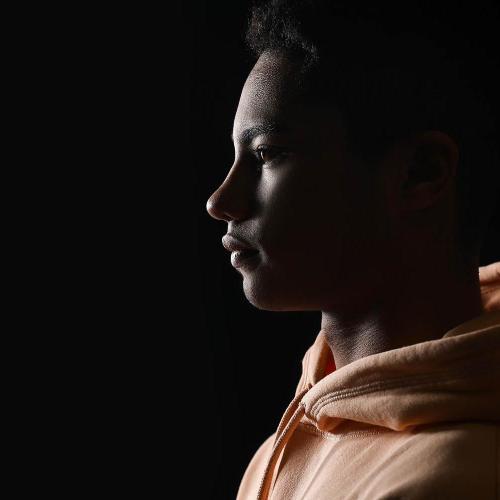 A teenage boy in profile looking towards the left