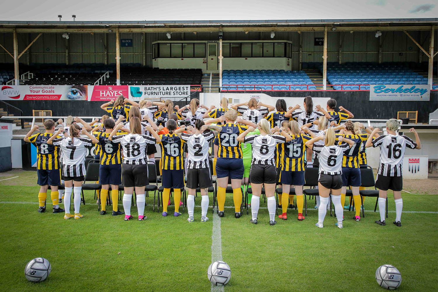 The Bath City women's team show off their shirts with the Bath Spa logo