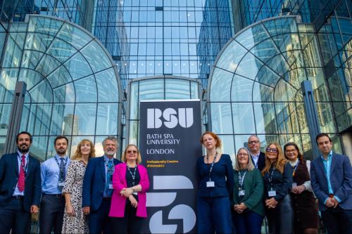 BSU colleagues pose in front of the new Canary Wharf site in London