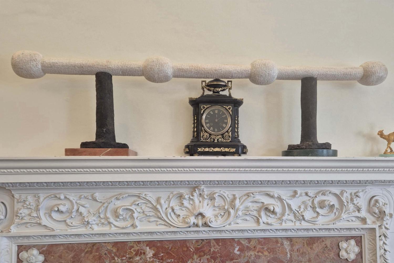 BSU's ceremonial mace resting on two marble plinths on a mantelpiece