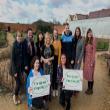 A group of people posing with signs that say 'I signed the pledge'