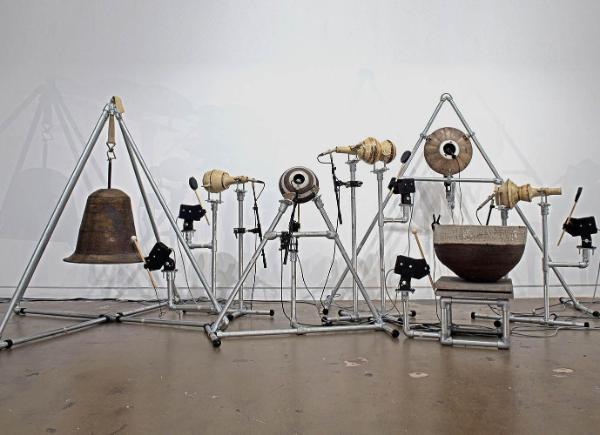 An art installation made of copper bells and metal pipes