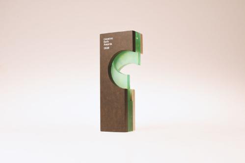 A rectangular shaped trophy with clear green glass, Bath stone and bronze elements