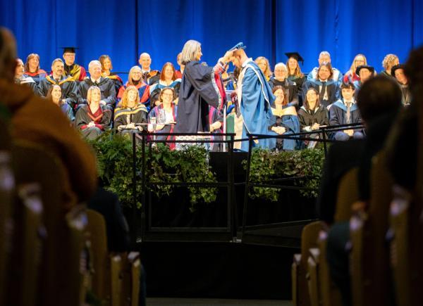 A doctorate being handed out to a student