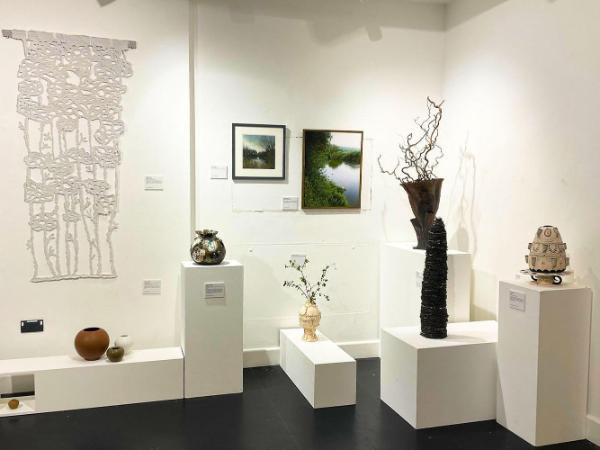art work of various mediums on display in a gallery