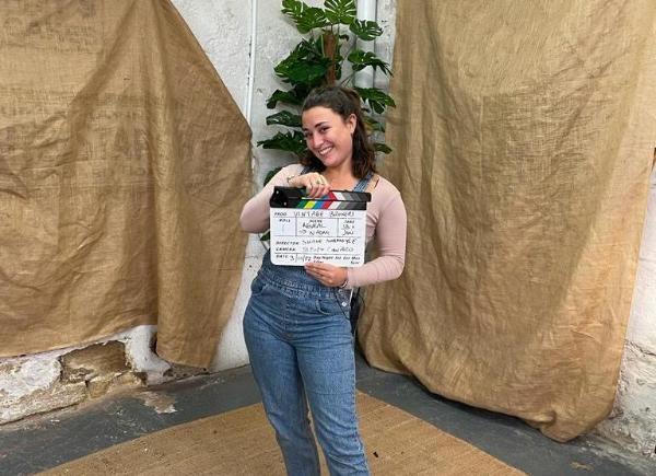 Emily Hayter poses with a clapperboard
