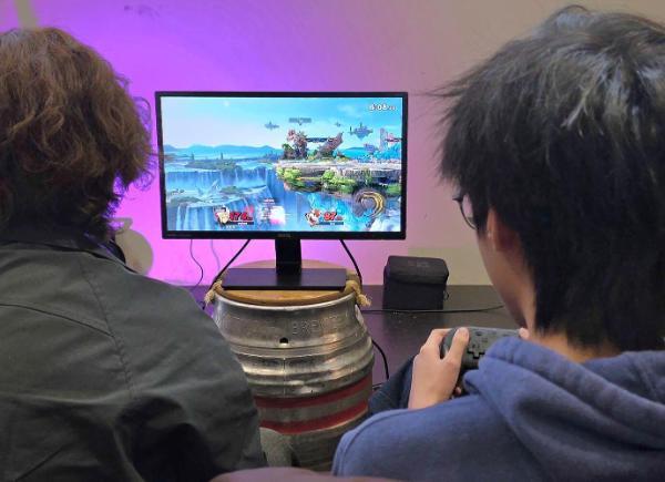 two people playing Super Smash Bros. on a console