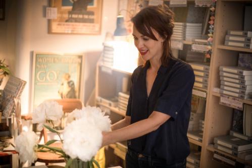 Francesca Beauman standing by some book shelves