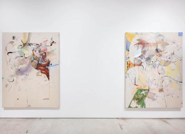 Two abstract paintings hanging in an art gallery