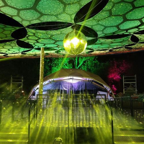A Glastonbury stage with green lights and decoration