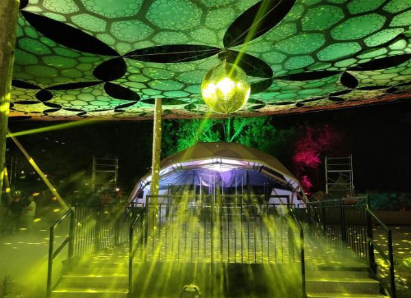 A Glastonbury stage with green lights and decoration