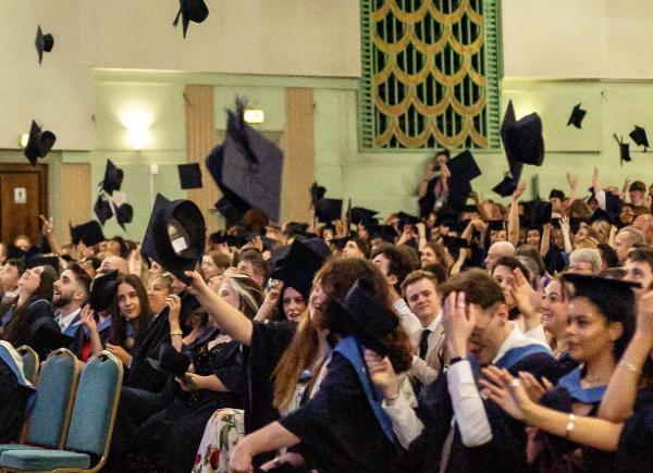 Graduates throwing their hats in the air