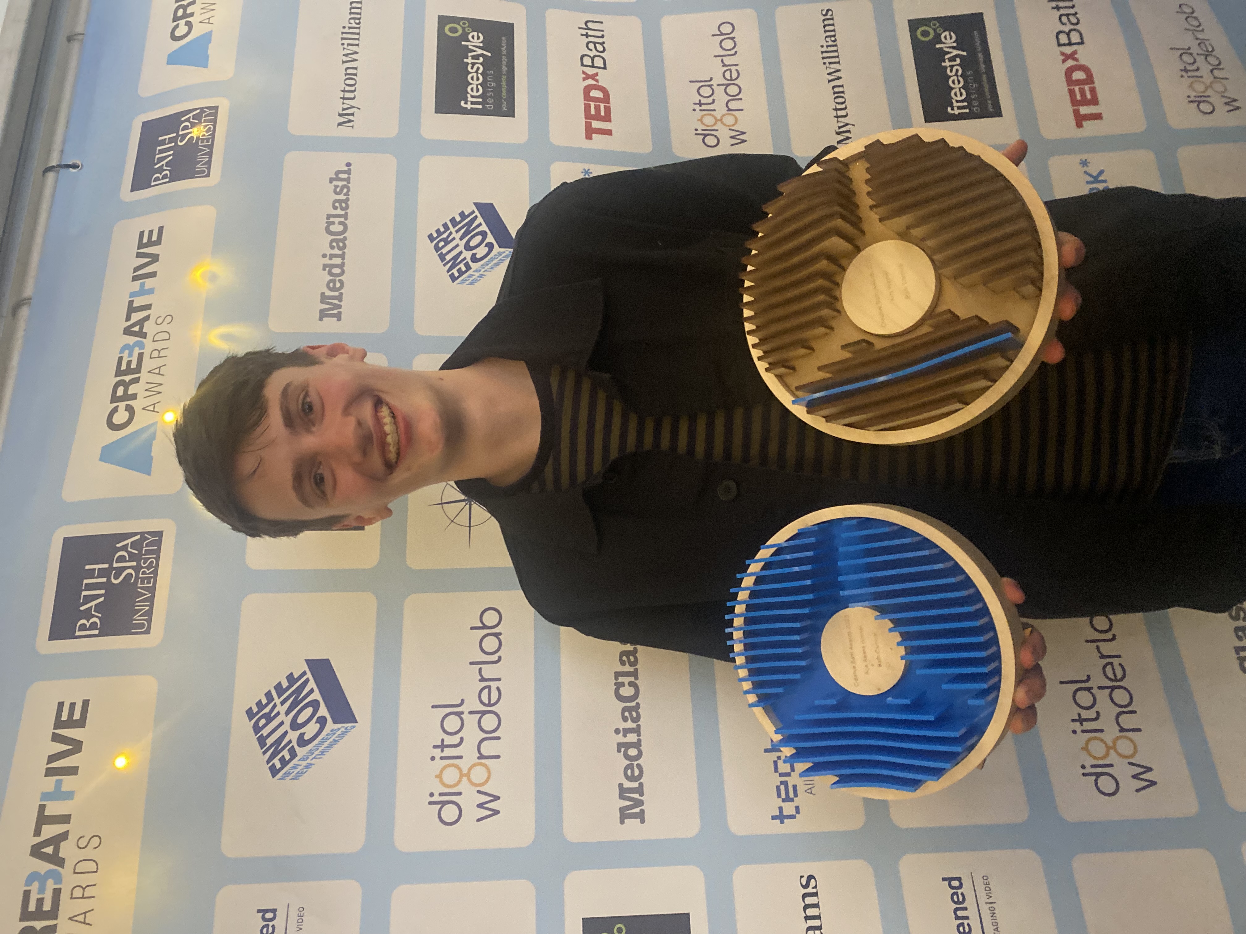 Bath Spa student Bo Neville with the award they designed for the 2023 Creative Bath awards
