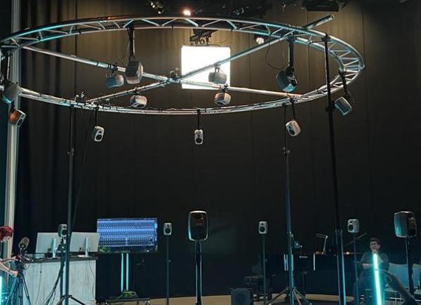 Interior of the TV studio with soft blue lighting and various sound equipment set up