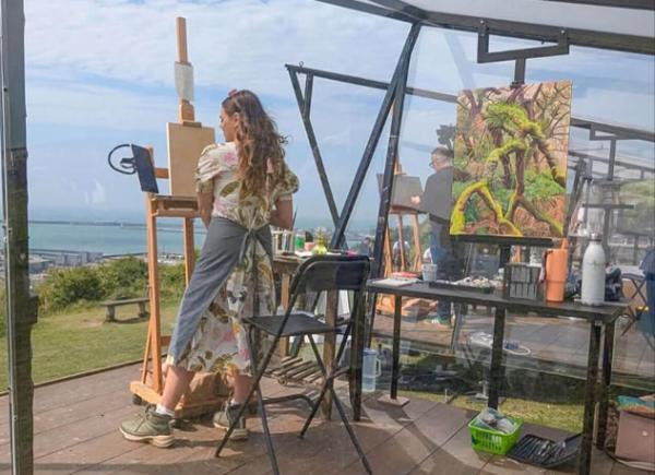 Student painting a landscape