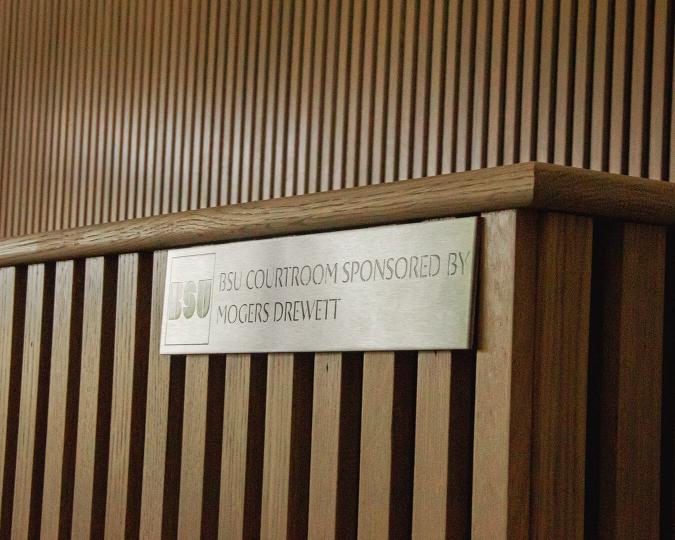 A close-up of a plaque that reads BSU courtroom sponsored by Mogers Drewett