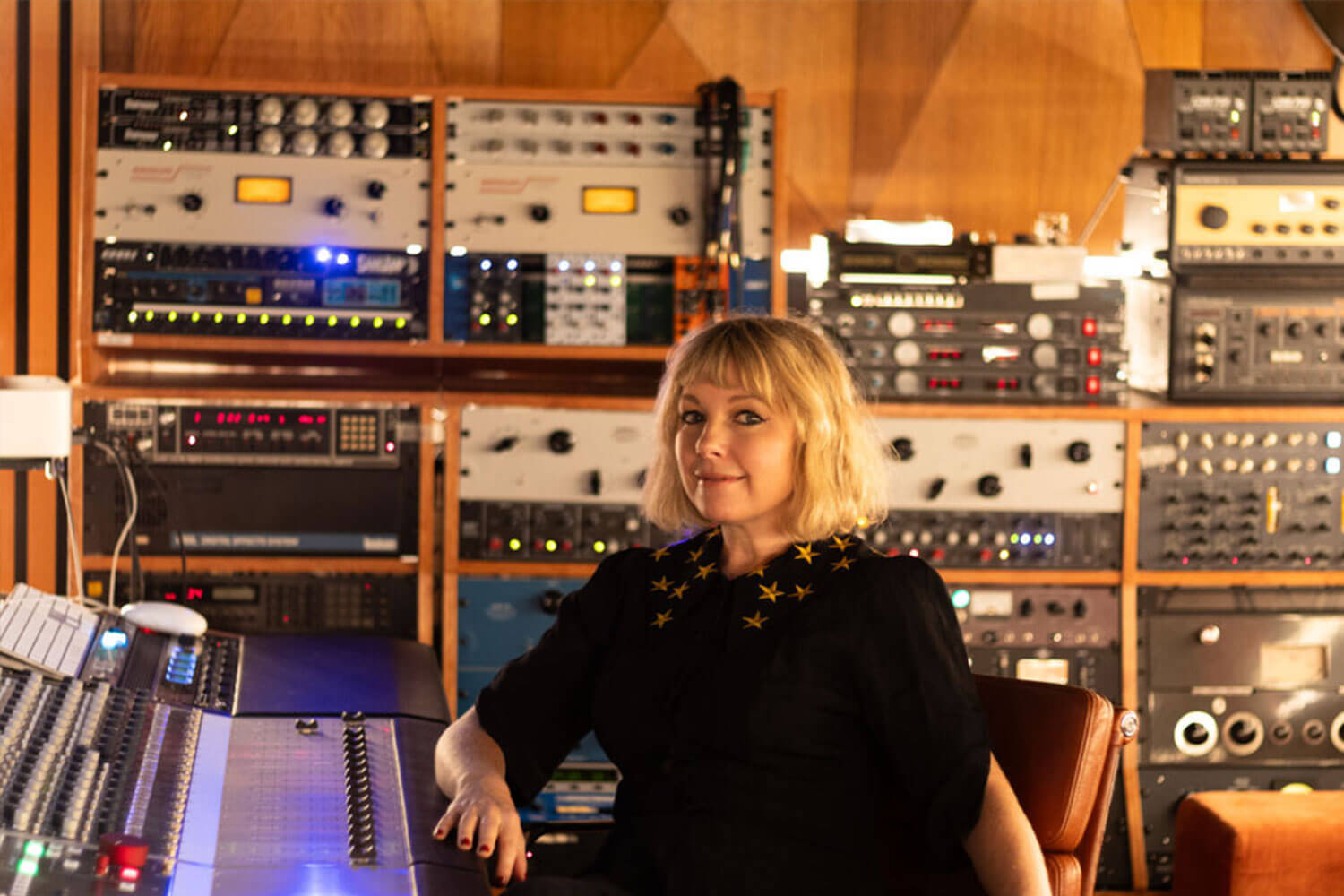 Person sits at mixing desk in BSU's commercial music studio